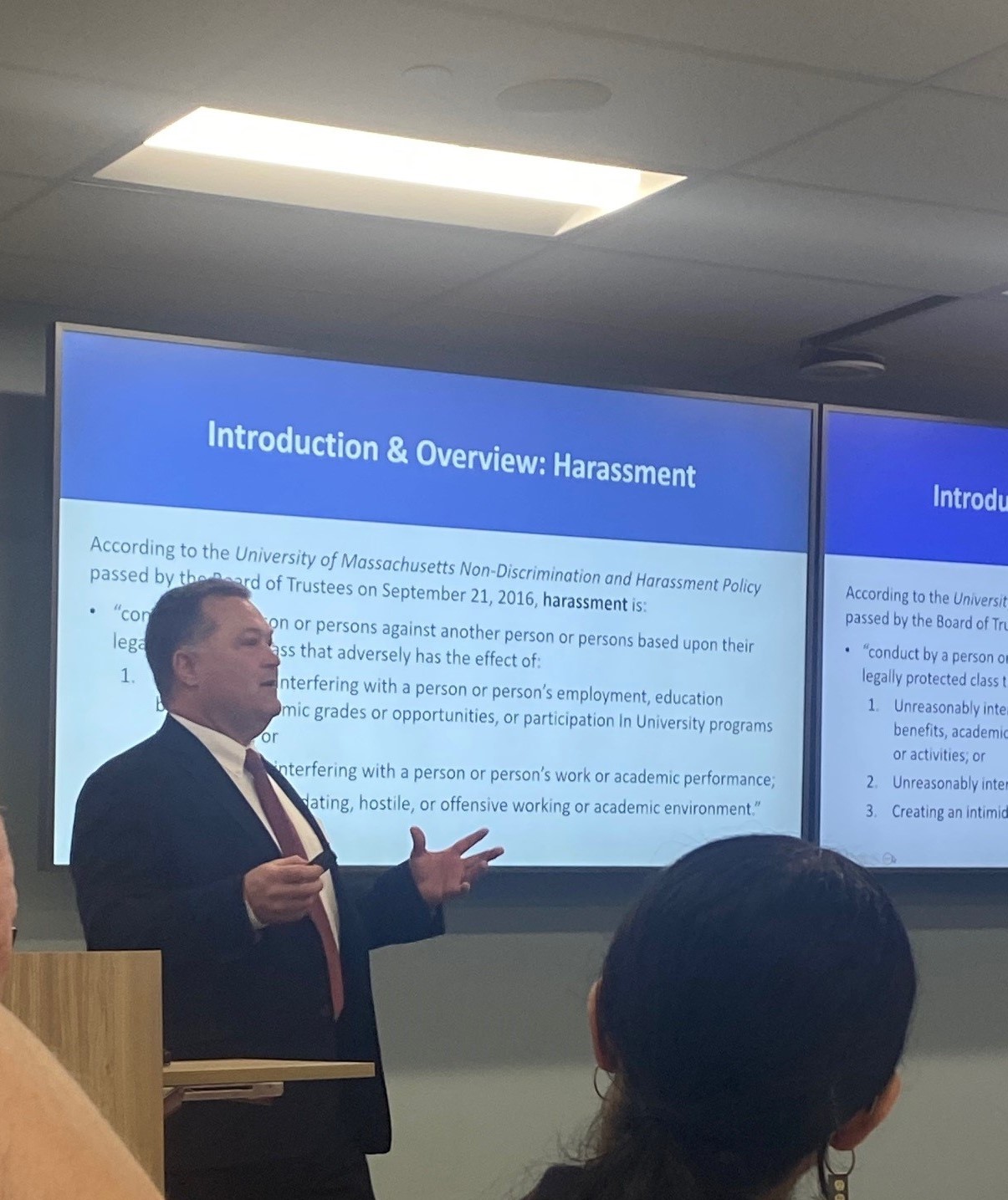 Man at podium conducting a training