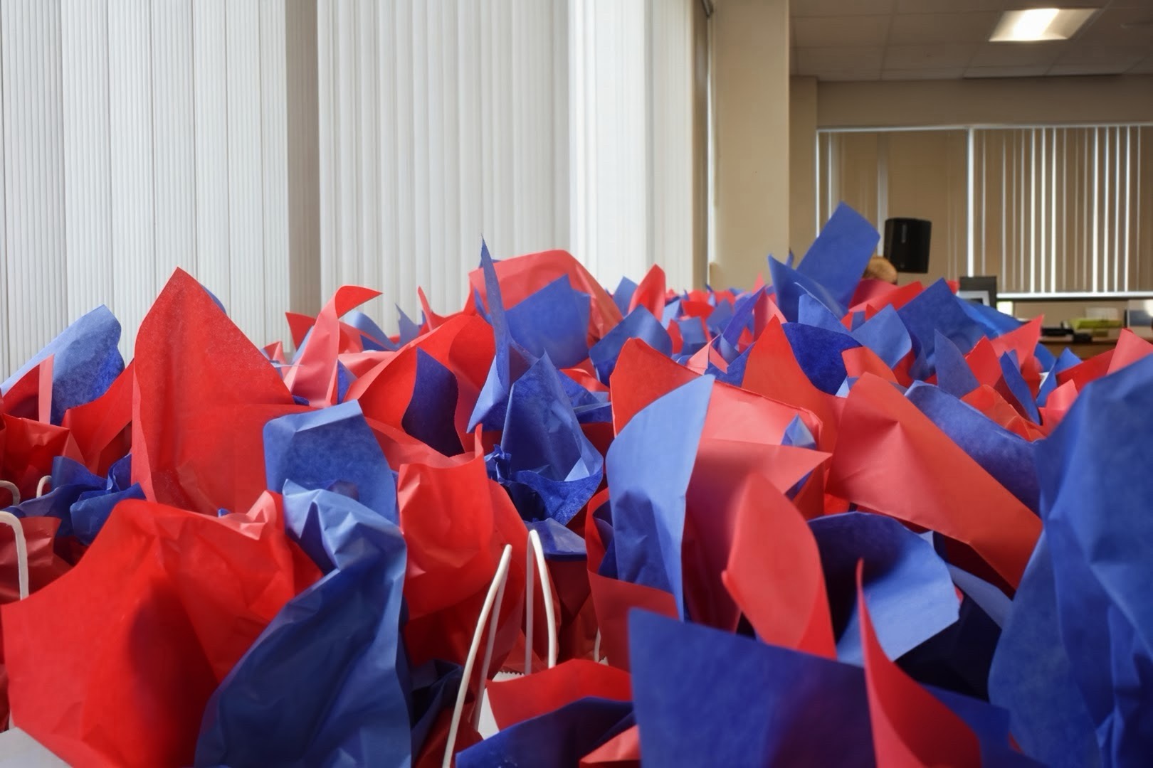 Red and blue giftbags with shirts for the team