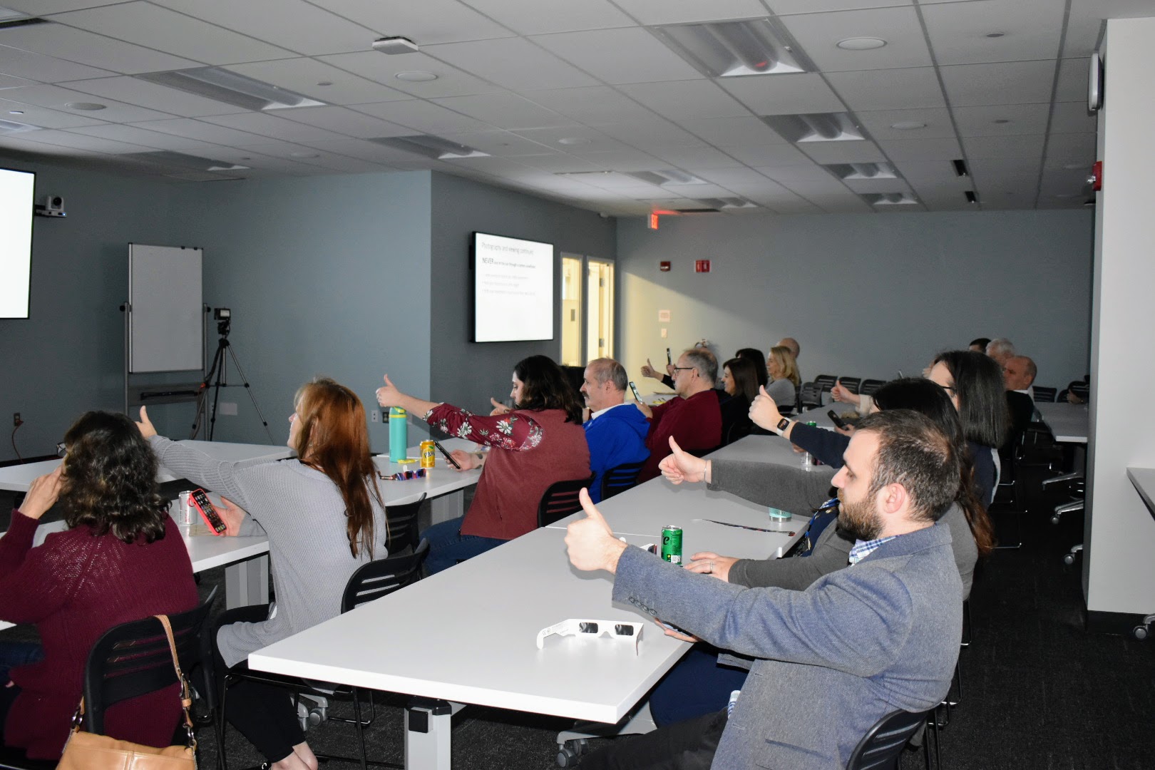 Group of people holding thumbs out