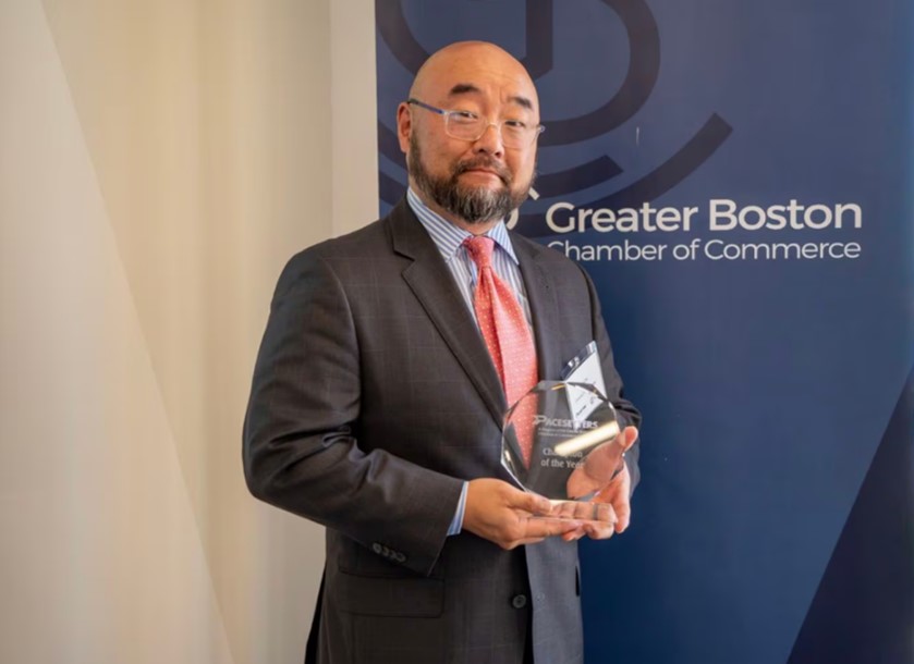 David Cho posing with an award