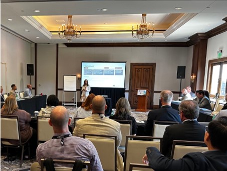 Anne Zuev presenting in front of a group of people sitting