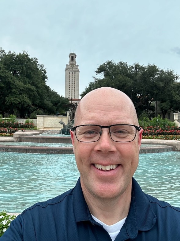 Photo of Michael Durkin in front of a fountain