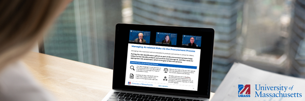 Image of desk with a laptop showing a zoom meeting and presentation