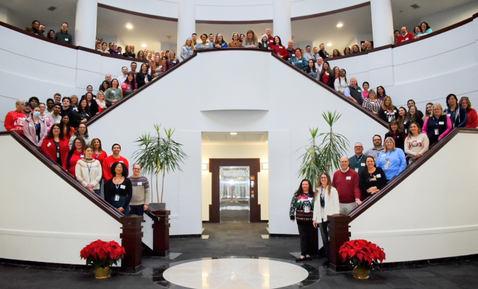 The A&F team posing for a photo on stairs in the foyer