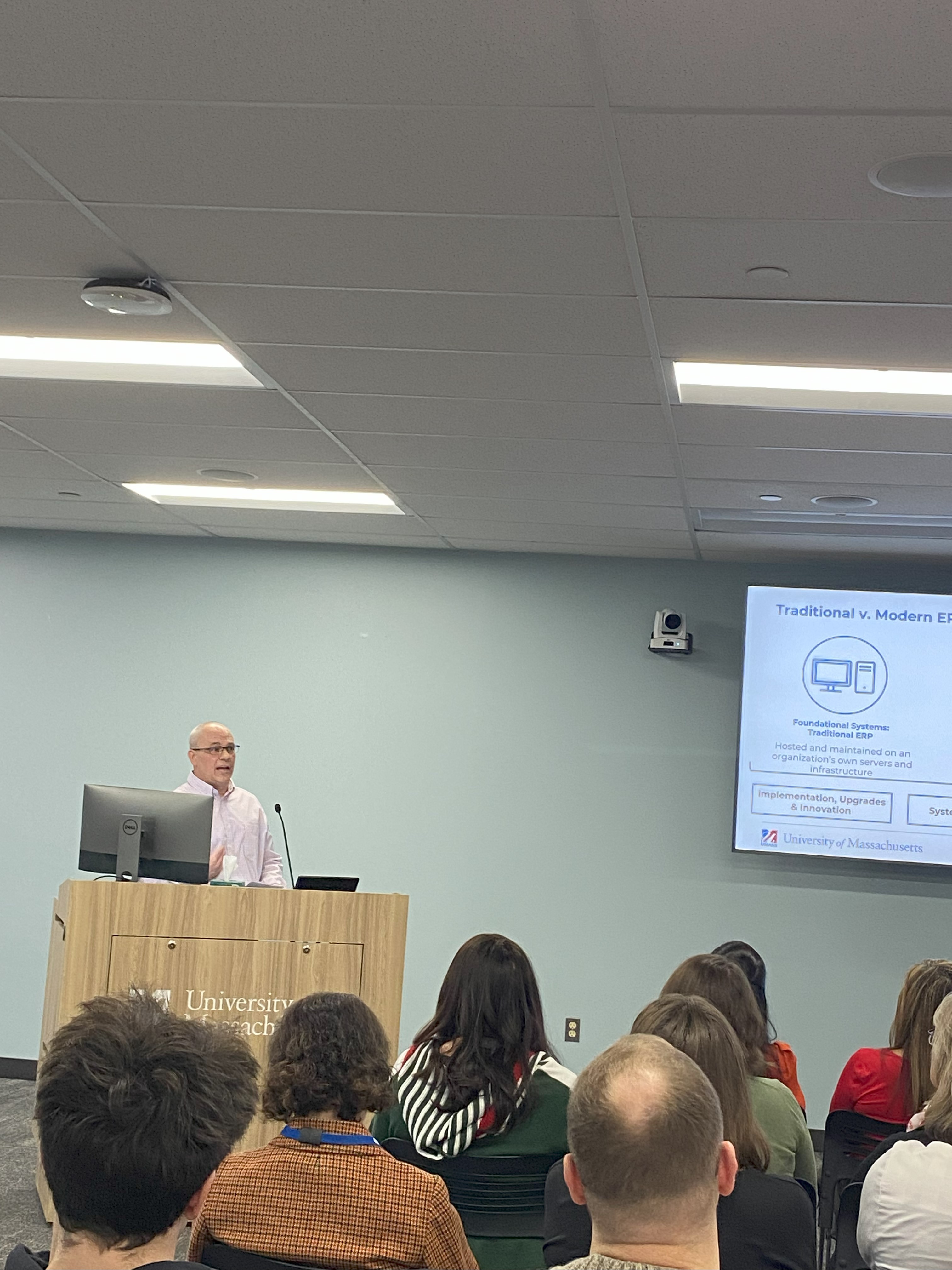 Brian Girard presenting to a group from a podium