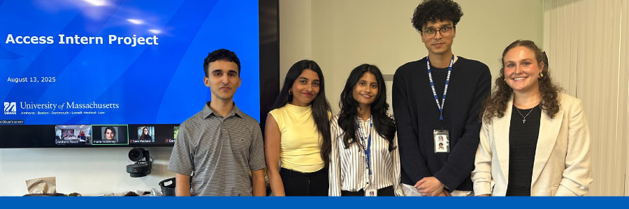 Group of multicultural students smile and pose in front of ppt that says "Access Intern Project"