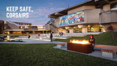 UMass Dartmouth campus at twilight with keep safe message