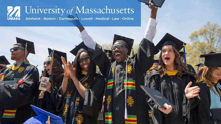 a small group of diverse students celebrating graduation with full umass logo in upper left corner