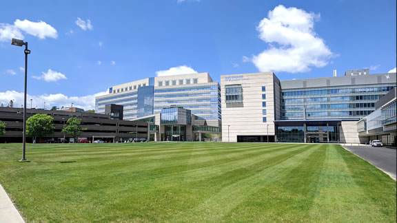 Medical School buildings across the lawn with blue sky behind