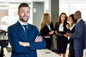 image of man in a suit standing in front of a group