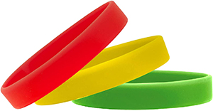 A red, yellow, and green bracelet stacked together.