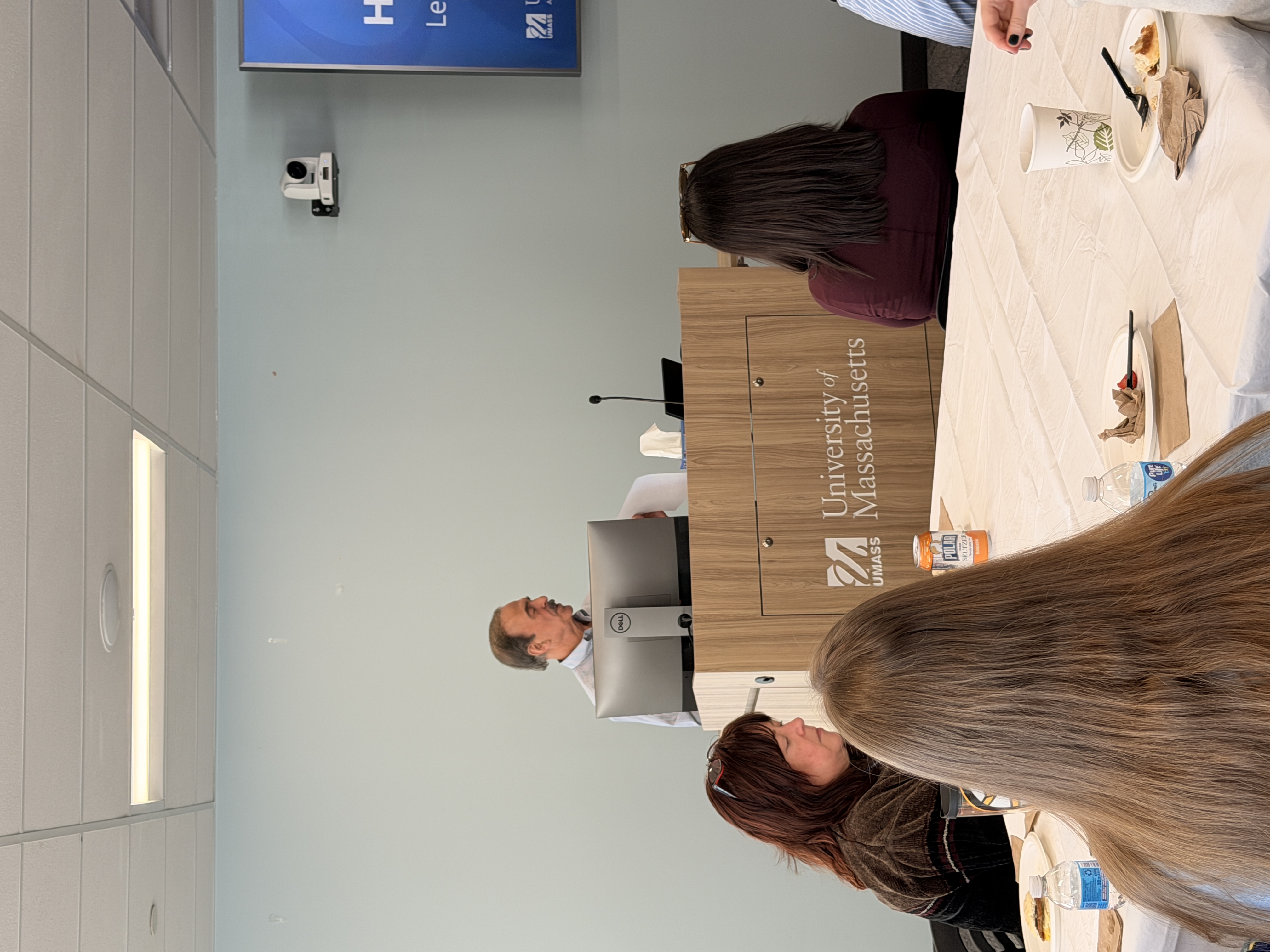 John Roy presenting behind a podium