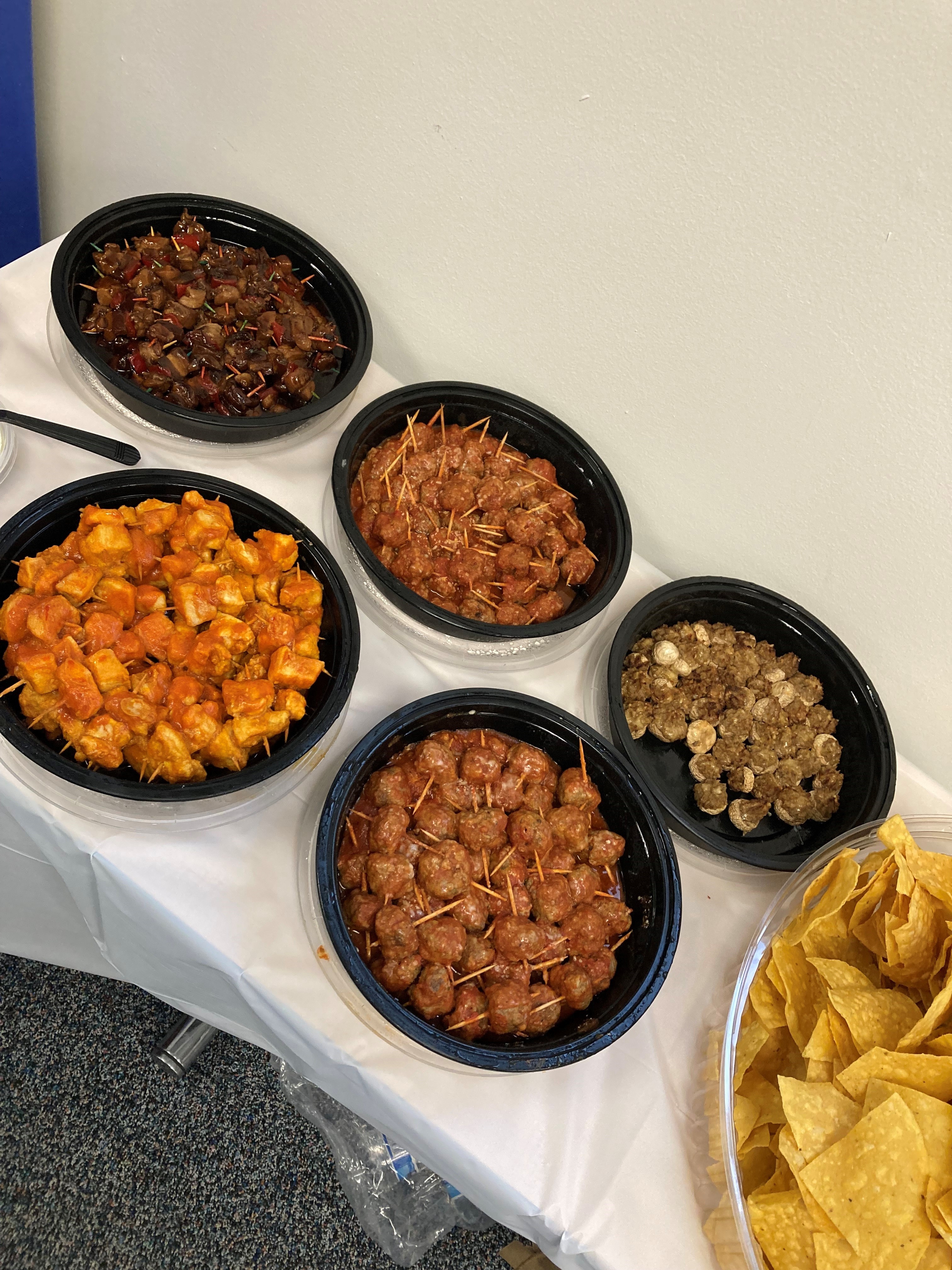 Circular trays of meatballs, buffalo chicken, and other snacks