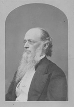 The side profile of a light-skinned man with gray hair and a white bird in a dress coat and vest.