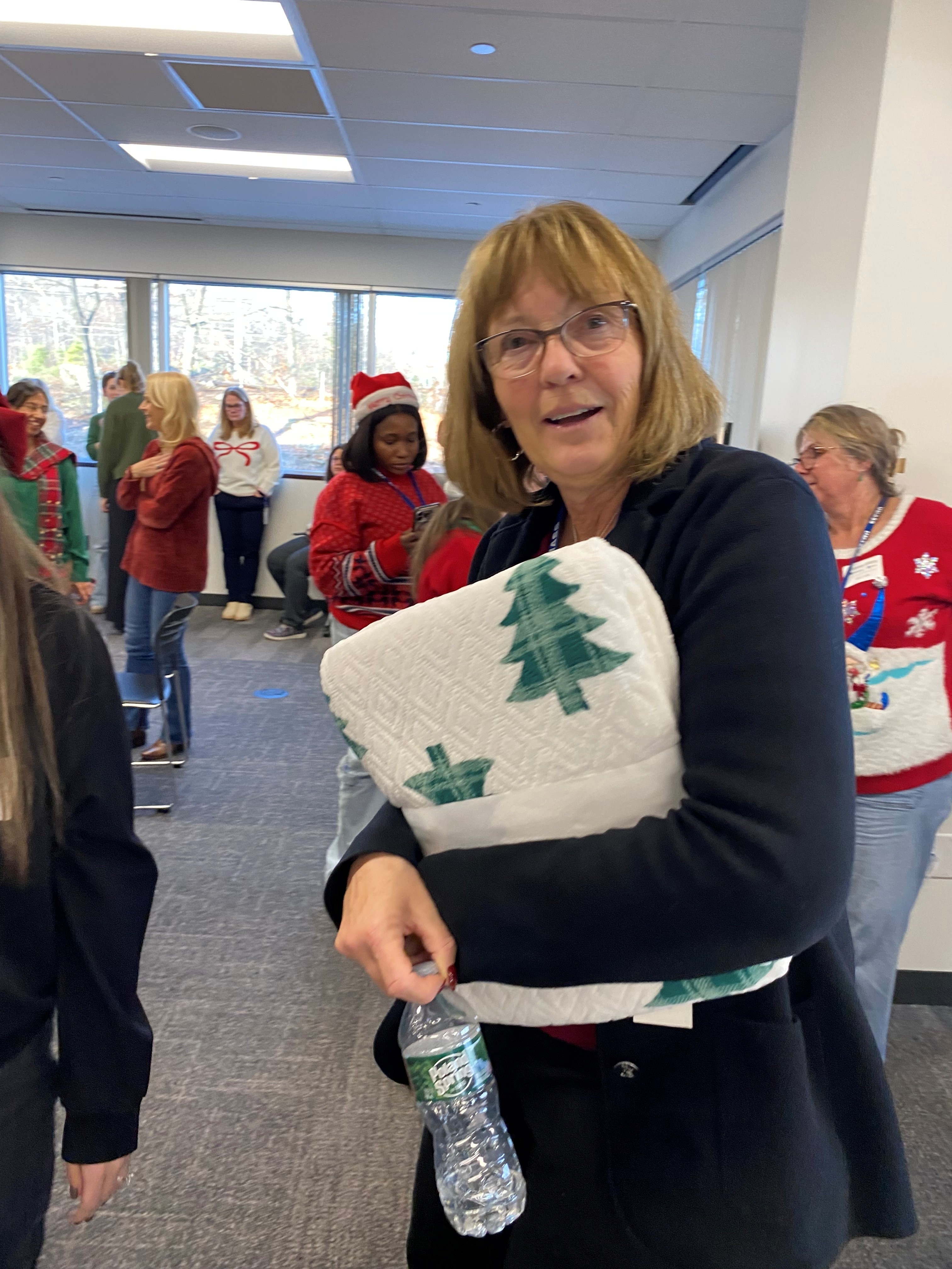 A women in black sweater holding a gift