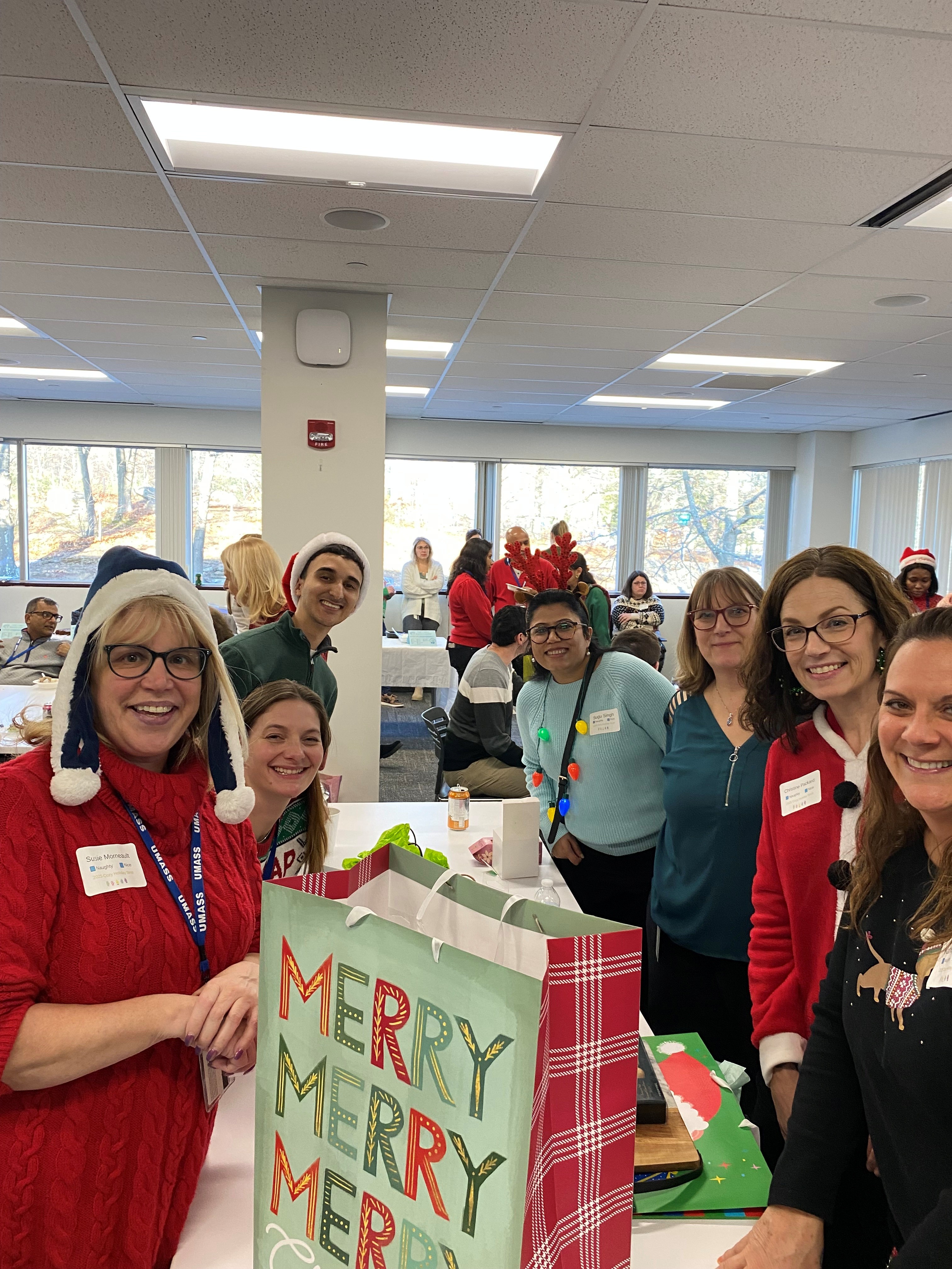 A group of people swapping wrapped gifts at a holiday party