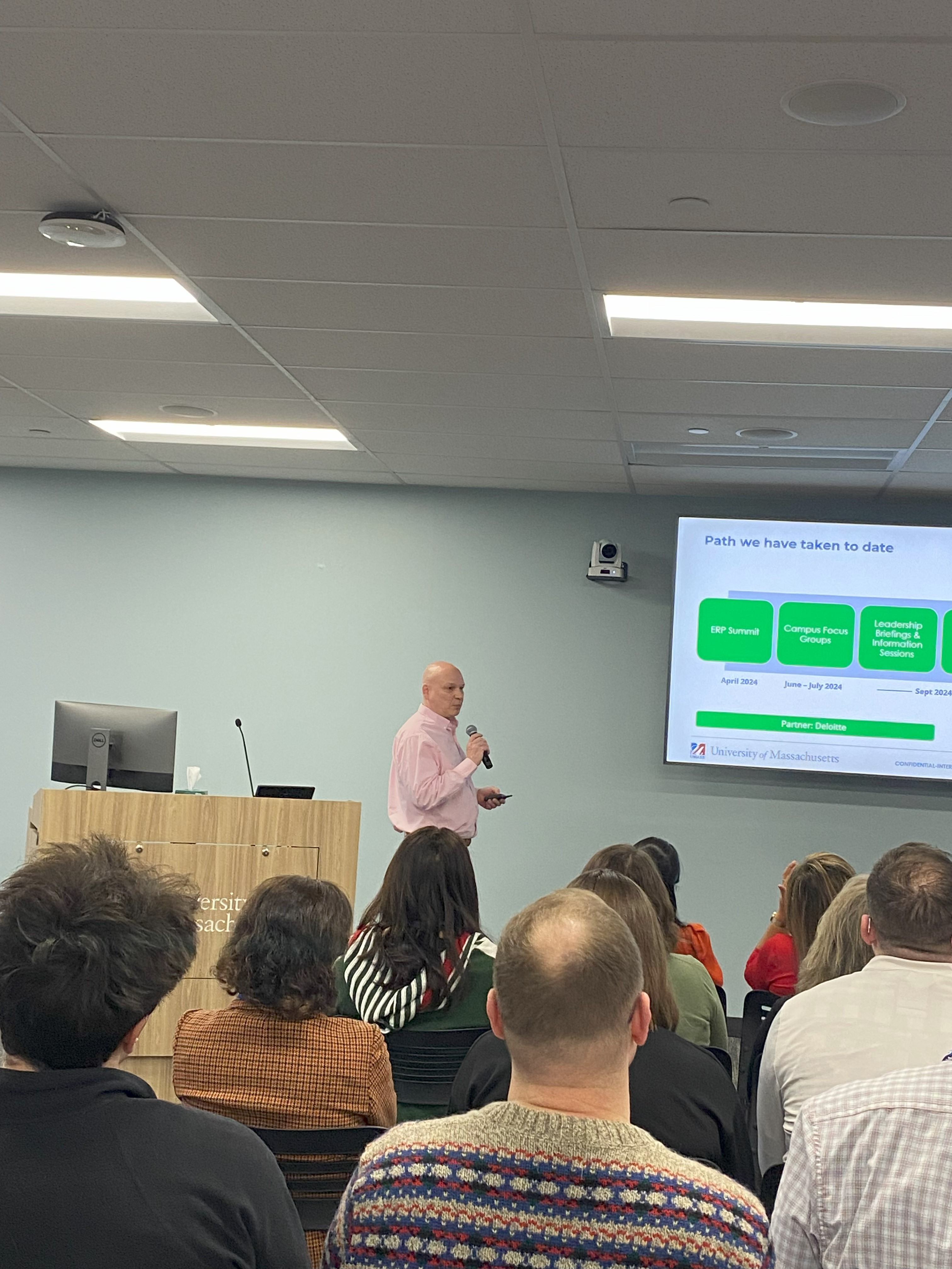 Jason MacFadyen presenting to a group in front of a screen