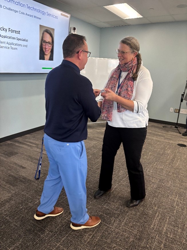 Michael Milligan and Becky Forest shaking hands