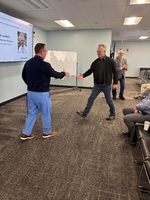 Michael Milligan and Scott Szajna shaking hands