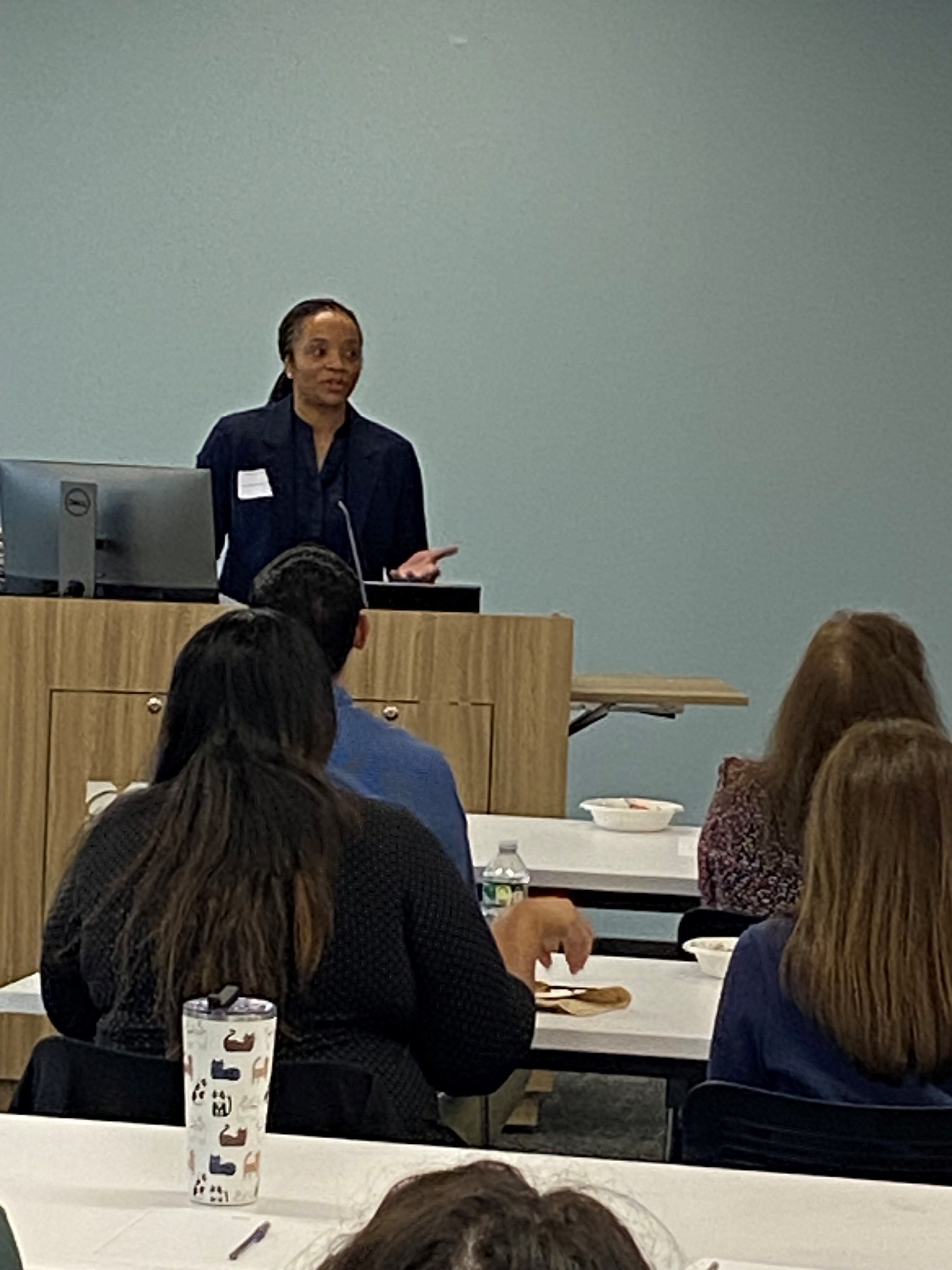 Nefertiti Walker, PhD, Academic Affairs presenting behind a podium