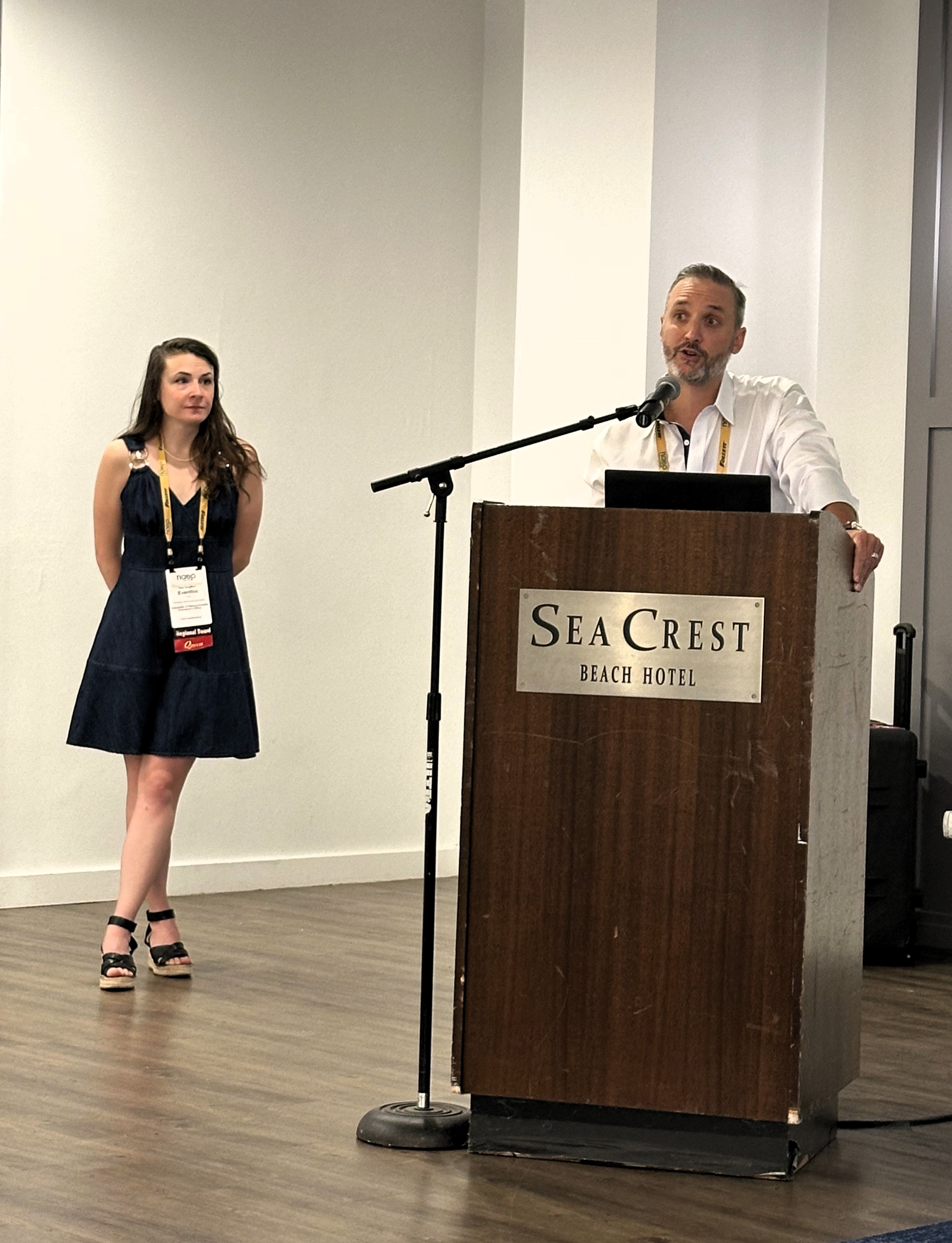 Evanthia Tully and Bill Mannix presenting behind a podium