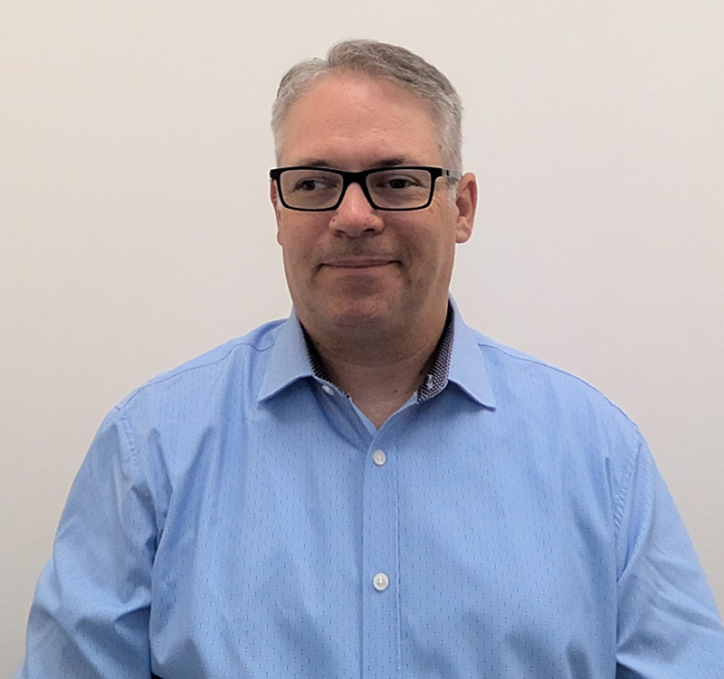 A light skin male with glasses in a blue shirt