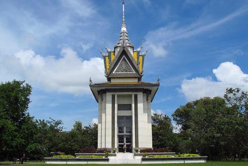 A white building with a golden roof.