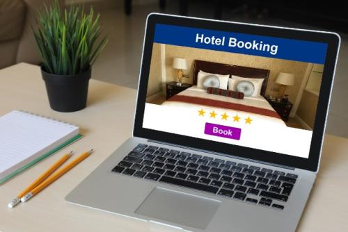 laptop screen with 'Hotel Booking' on it