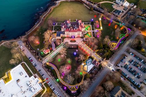 A drone shot of a Newport mansion with Christmas lights. 