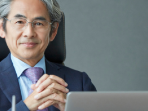 Professionally dressed man sitting behind computer