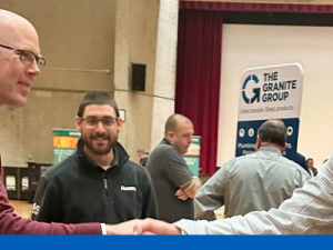 Photo capturing suppliers and UMass employees talking with each other at event