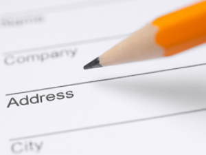 Close up of pencil filling out a form with fields that say name, company, address