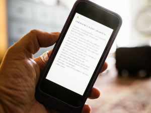 person holding phone reading a notification