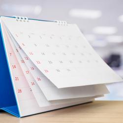 A calendar sits on a desk. 