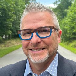 c edward watson, a gray-haired man with a grey beard wearing eye glasses and wearing a suit