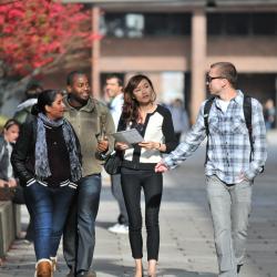 Group of students walking on a campus.