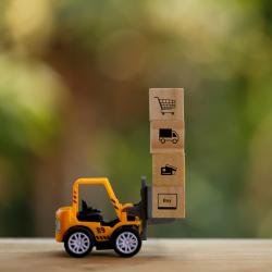 A construction truck carries wooden blocks with various shopping symbols.